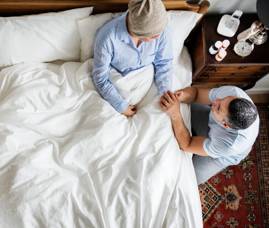 Caring for cancer patient in bed